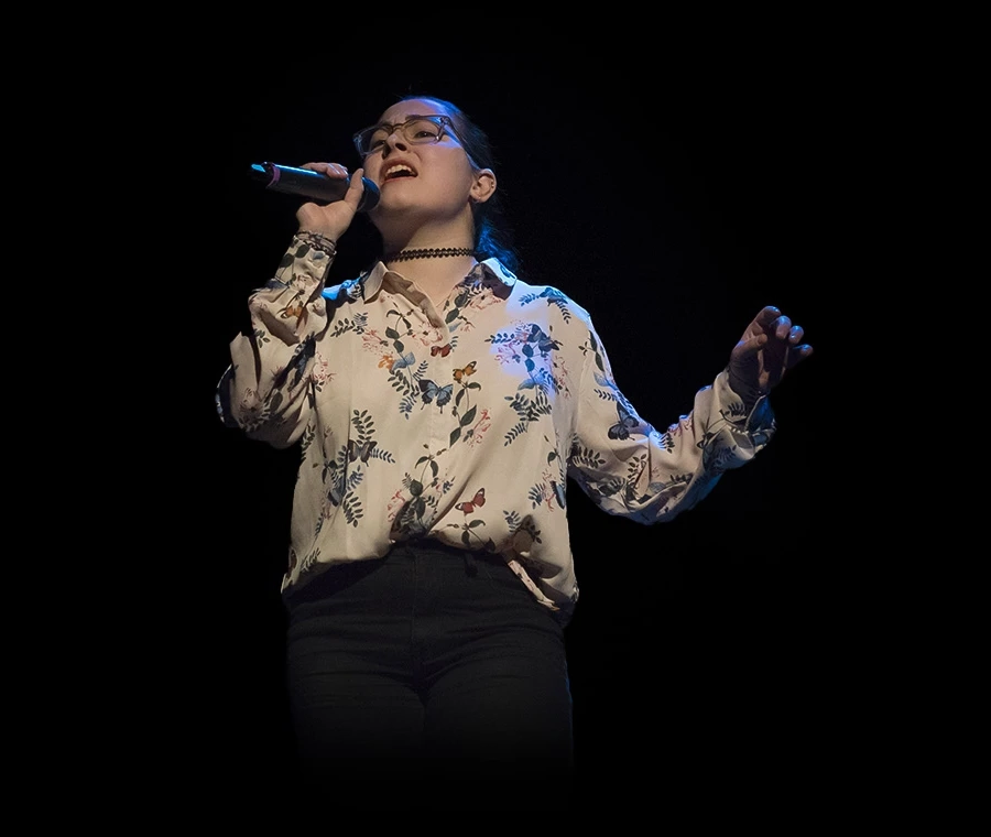 singer on a dark stage